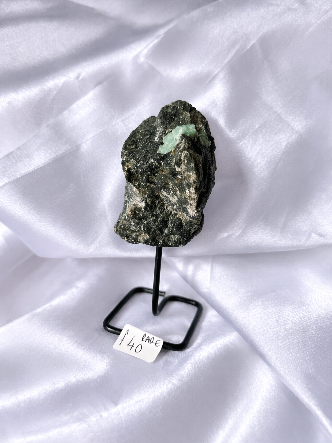 Raw emerald on a stand